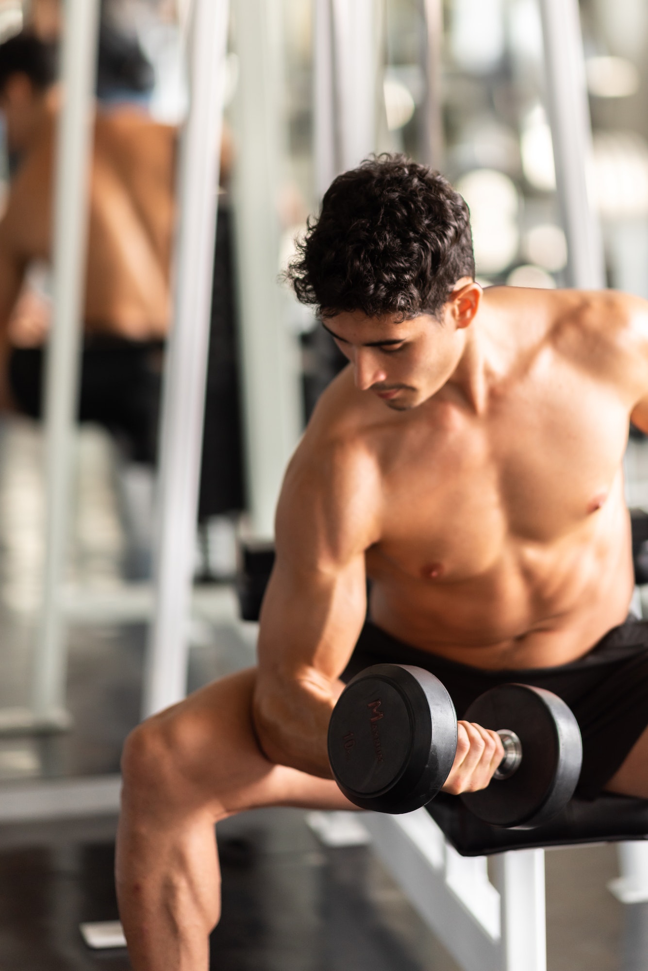 strong man exercising in the sport gym, workout exercise training in fitness for body strong