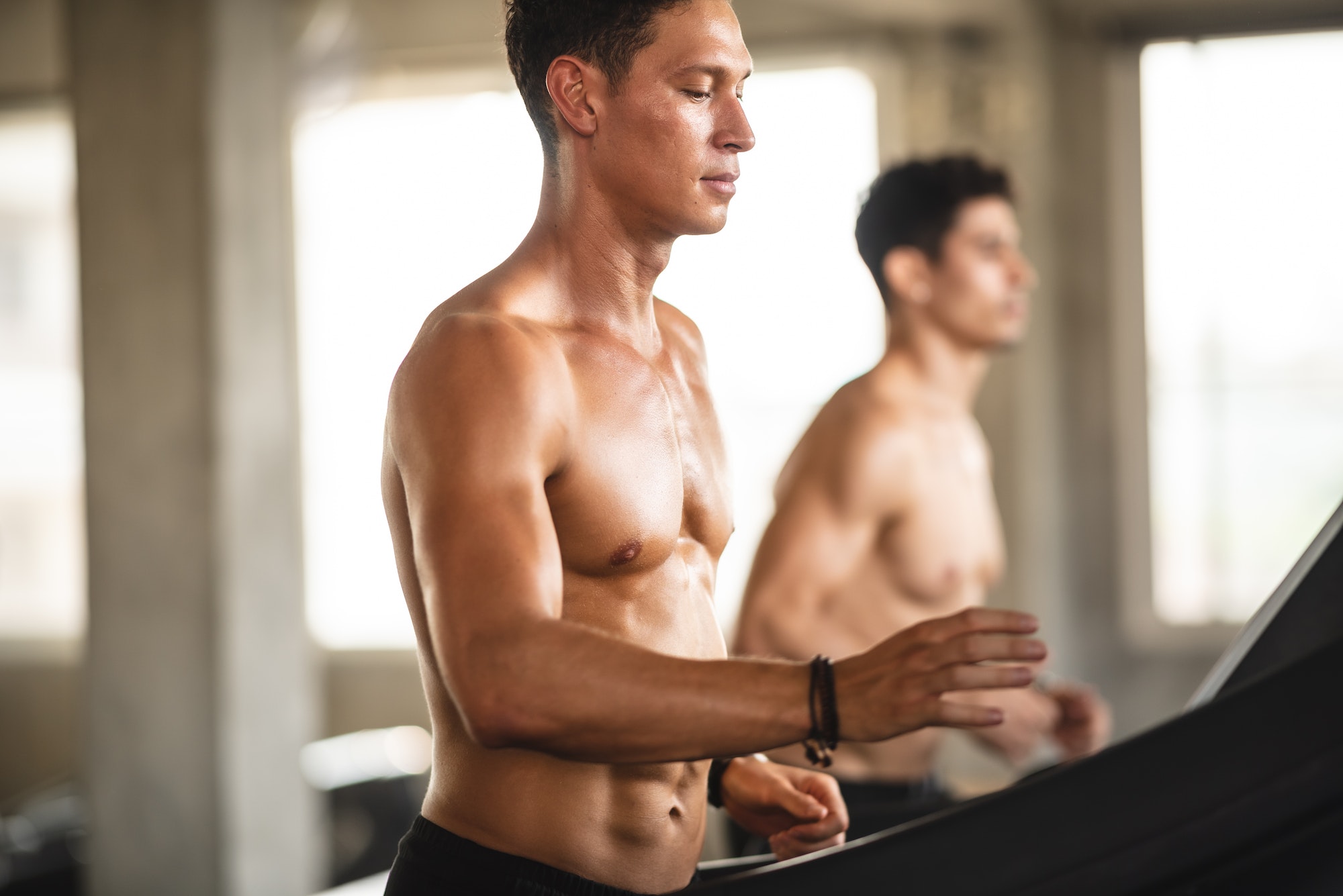 strong man exercising in the sport gym, workout exercise training in fitness for body strong